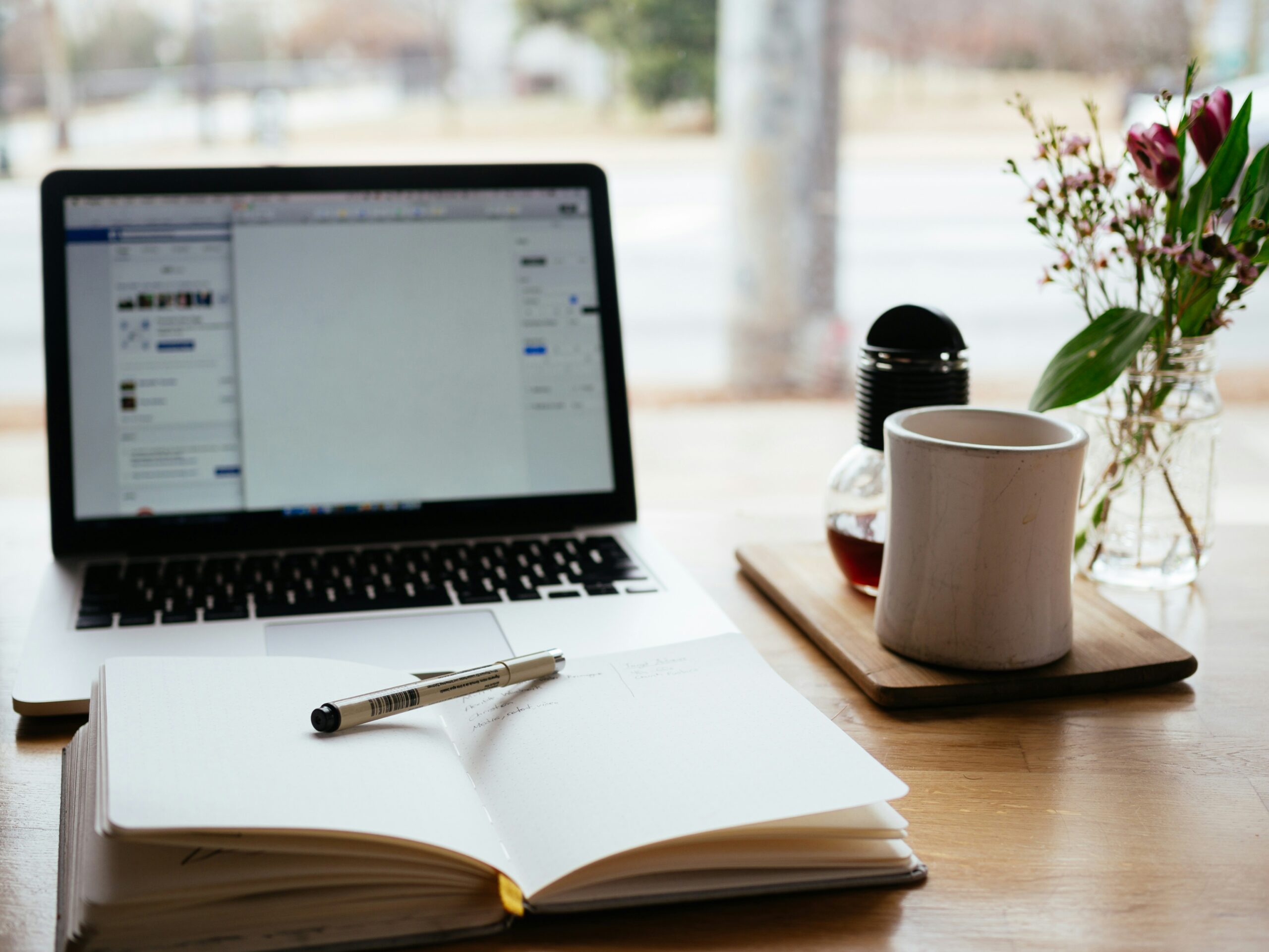 An image of a well-organized desk with a laptop displaying 'Coursework Assignment Help' on the screen, surrounded by textbooks, notes, and a cup of coffee.